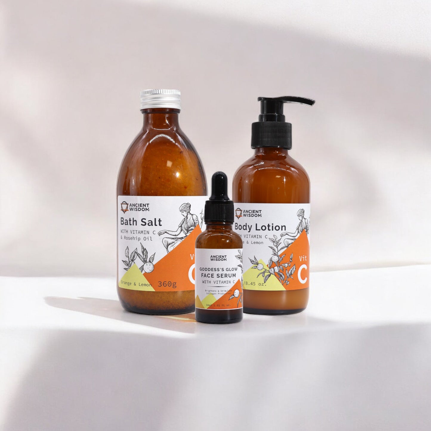 Three products with Vitamin C and essential oils for skincare. Bath salts, face serum and body lotion.