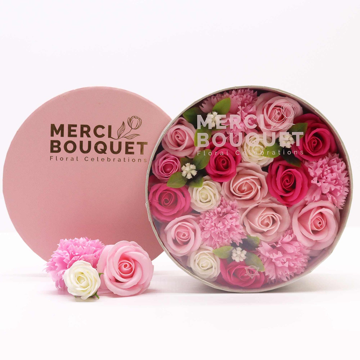 A round gift box full of pink, red and white soap flowers. Roses. The petals are made of soap.
