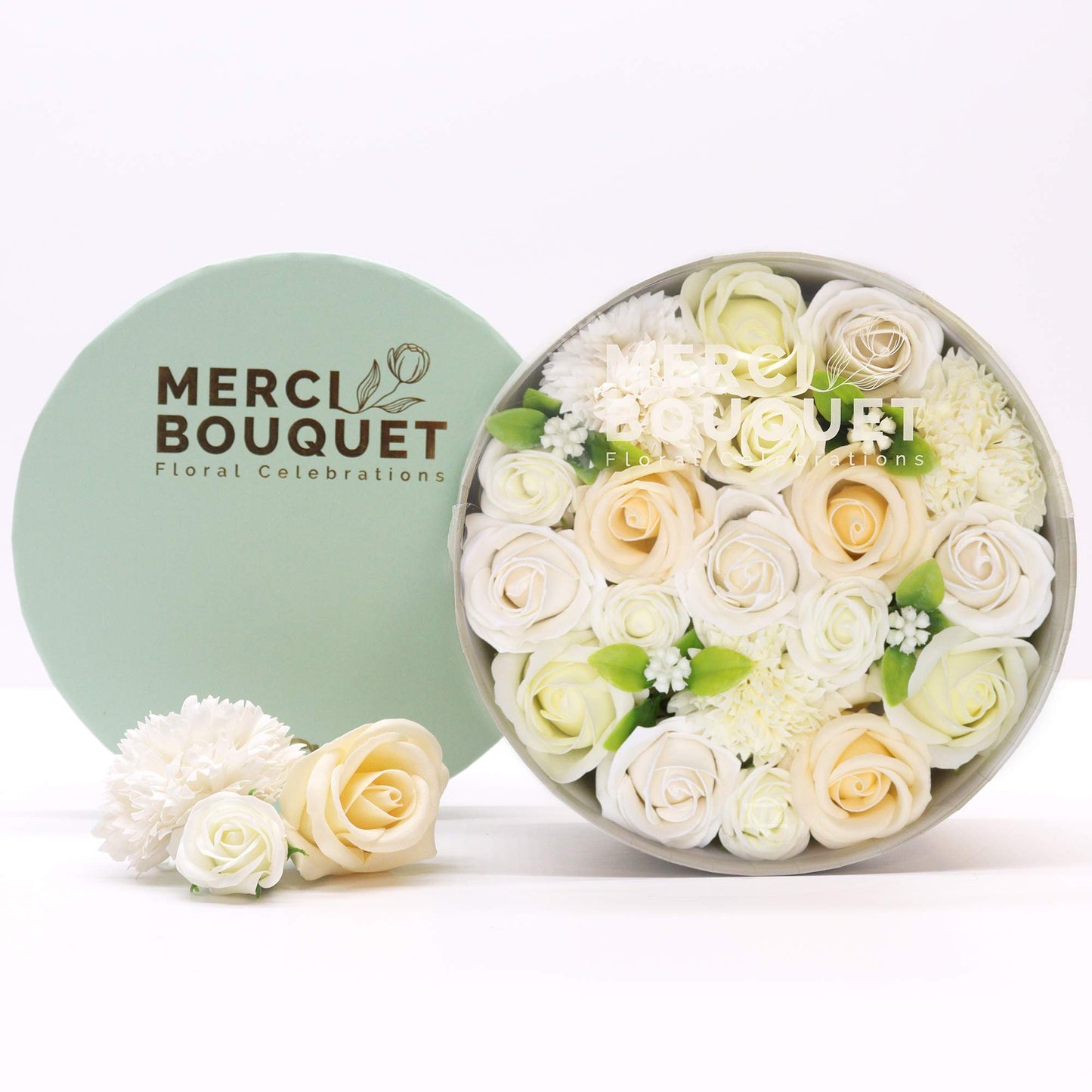 A round gift box full of white soap flowers. Roses. The petals are made of soap.