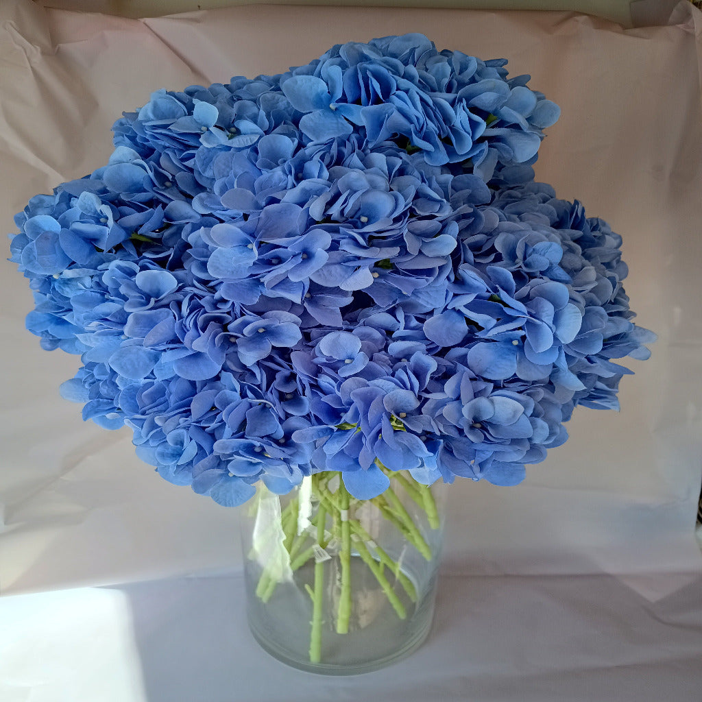 Beautiful artificial flowers in a glass vase. Blue hydrangeas. Easy to look after. Long lasting.