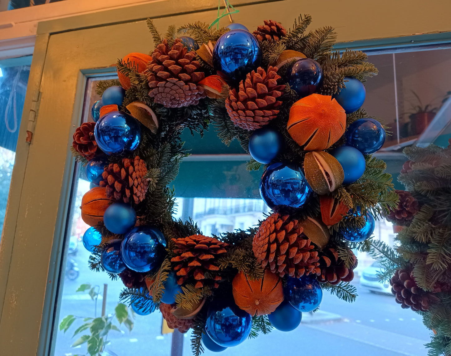 Exclusive, limited edition Christmas wreath with blue baubles, oranges and pine cones