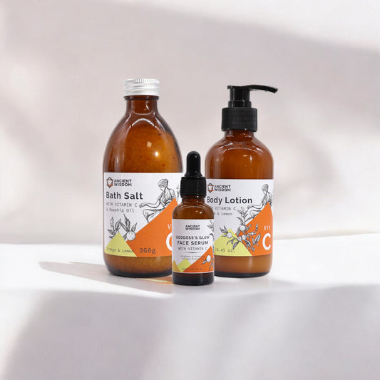 Three products with Vitamin C and essential oils for skincare. Bath salts, face serum and body lotion.
