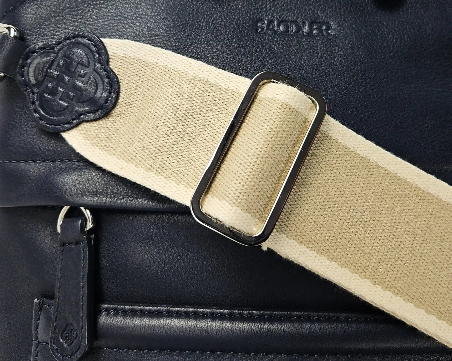 Close up of Kimberley leather crossbody bag with wide cotton strap.