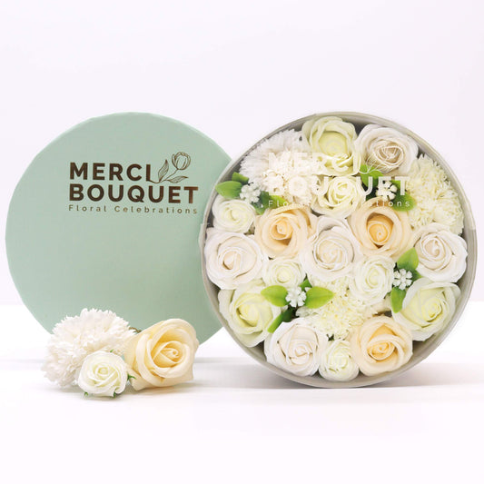 A round gift box full of white soap flowers. Roses. The petals are made of soap. 