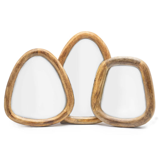 A set of three handmade mirrors. Pebble shaped. Natural mango wood frames. Each is a different size.