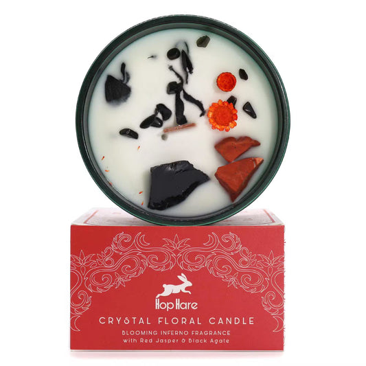 Handmade soy candle with real crystals and dried flowers. On a red gift box, featuring the brand 'Hop Hare'. 