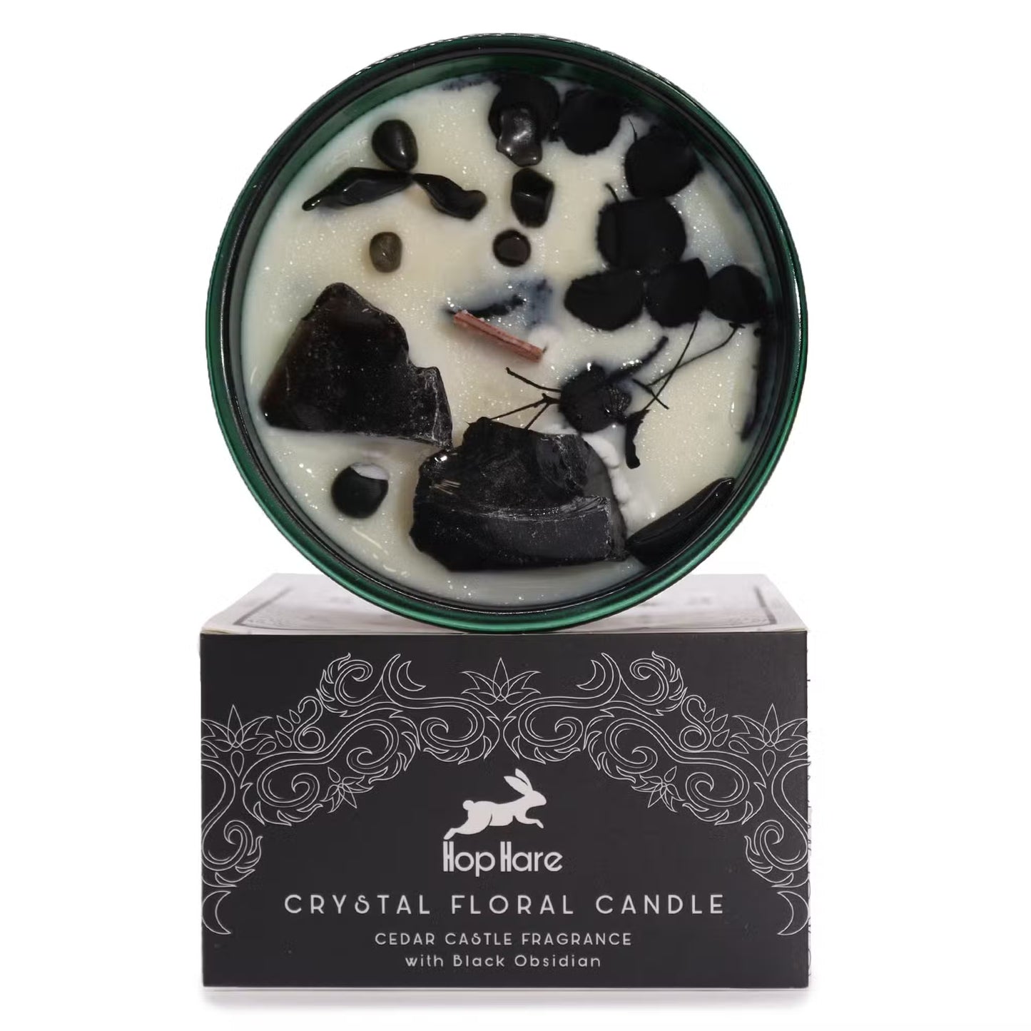 'The Knight of Swords' candle with Black Obsidian crystals and dried flowers. On top of a gift box.