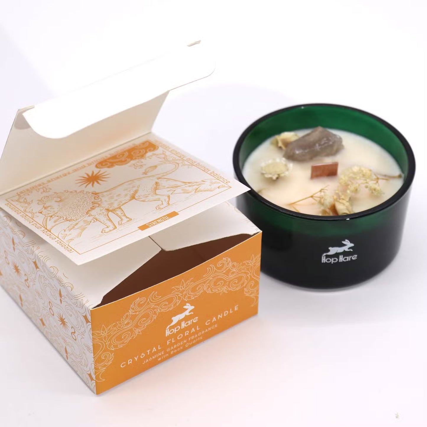 'The Lion' soy candle, with crystals and dried flowers, in a green jar with descriptive gift box.