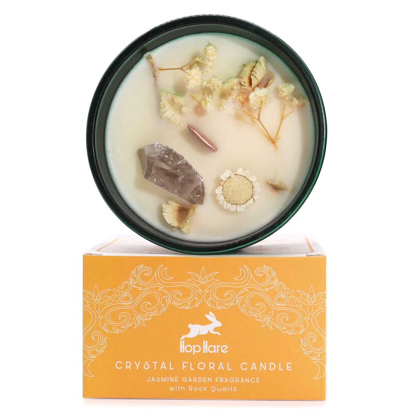 'The Lion.' Fragrance soy candle with Rock crystal and dried flowers. In a green glass jar. On top of gift box.