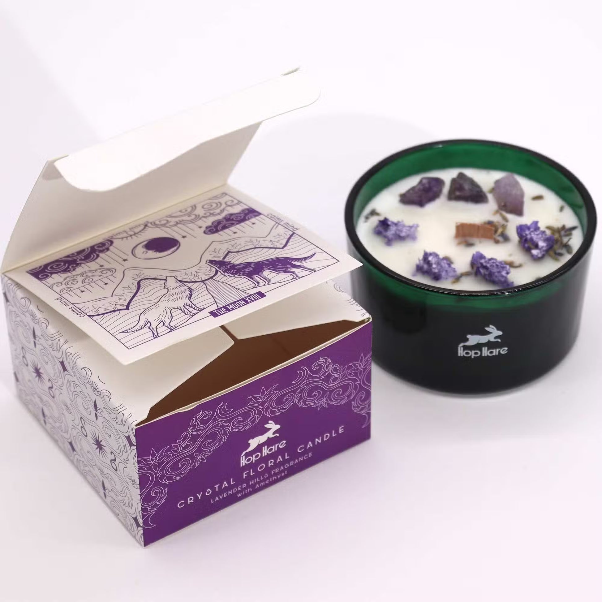 'The Moon.' Artisan Crystal floral candle in a green glass jar. Next to a decorative gift box.