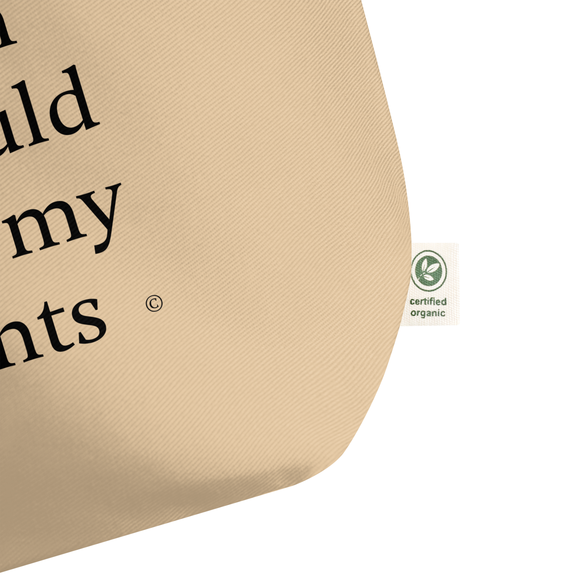 Large beige cotton tote bag. With exclusive black text about A.I. and a green organic cotton certification label.