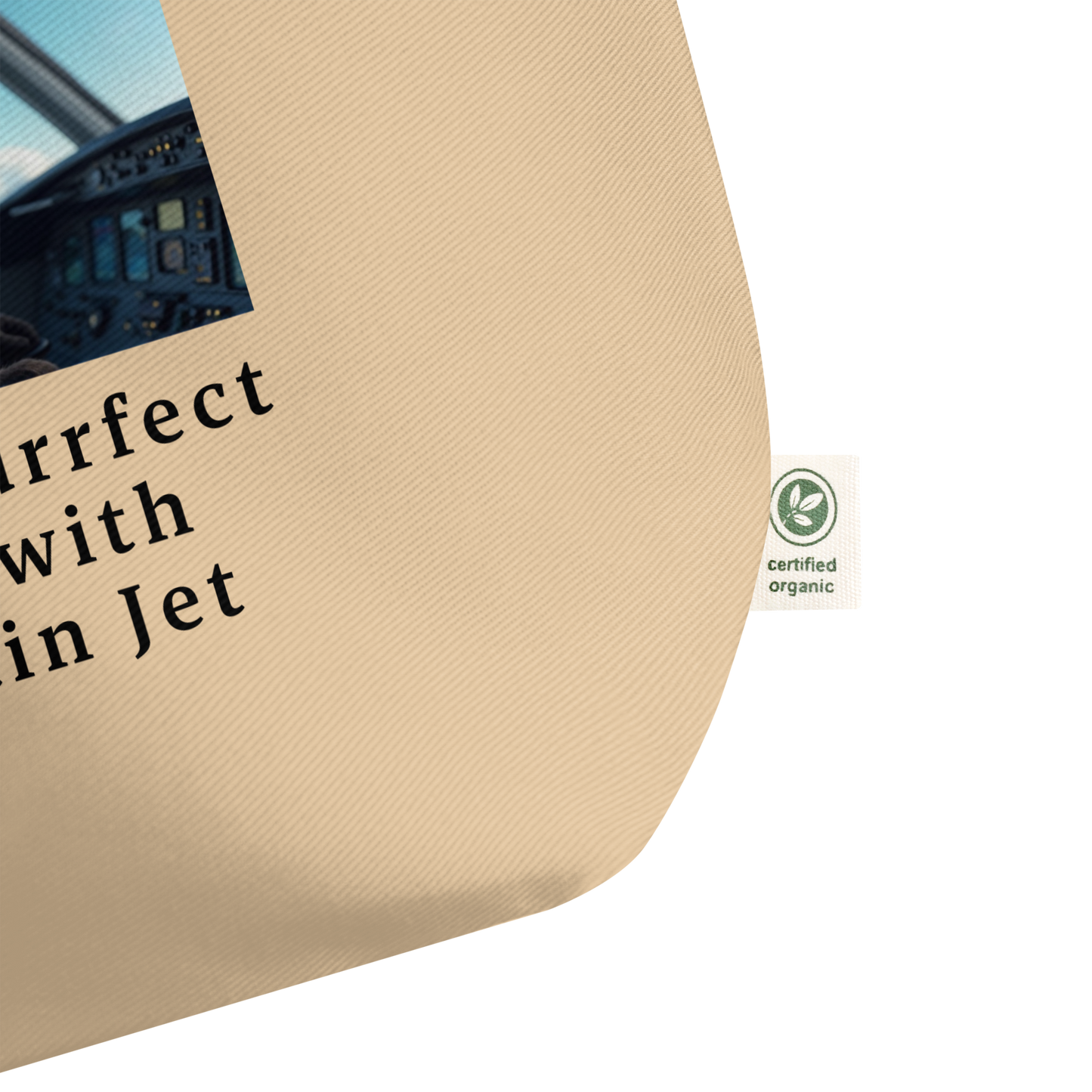 A certified organic cotton label on a large beige organic cotton tote bag. Also part of a print and text on the bag.