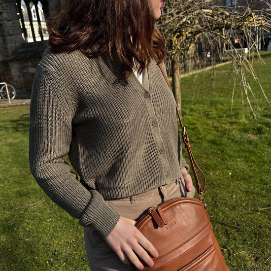 Tan leather crossbody bag worn by woman outdoors — Kimberley handcrafted leather bag