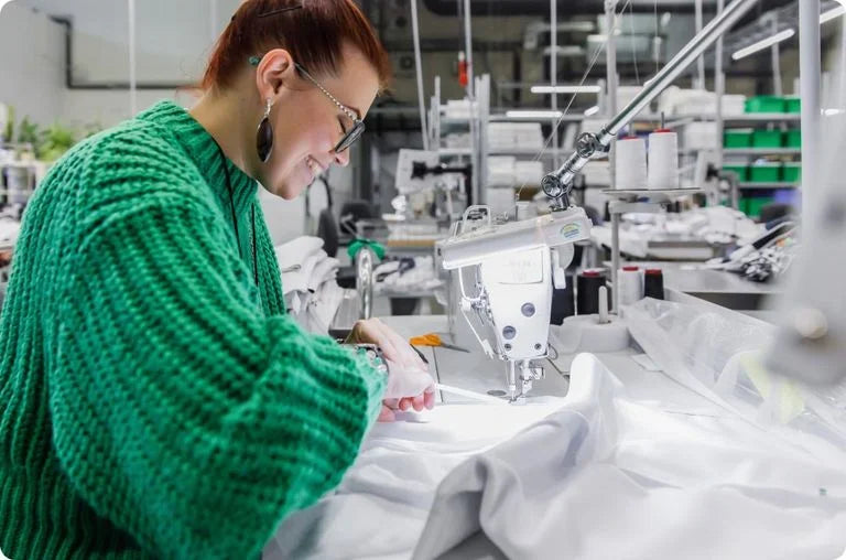 A skilled artisan sewing a product at an Avarosaluxe certified manufacturing facility.